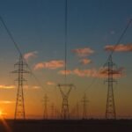 High-voltage power lines at dusk representing energy retail infrastructure