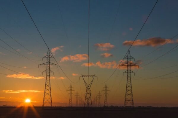 Origin Energy data breach: High-voltage power lines at dusk representing energy retail infrastructure