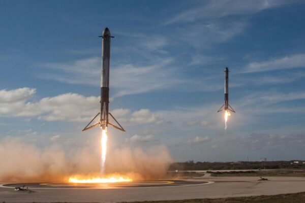 Rocket launching into a clear sky on a pillar of exhaust